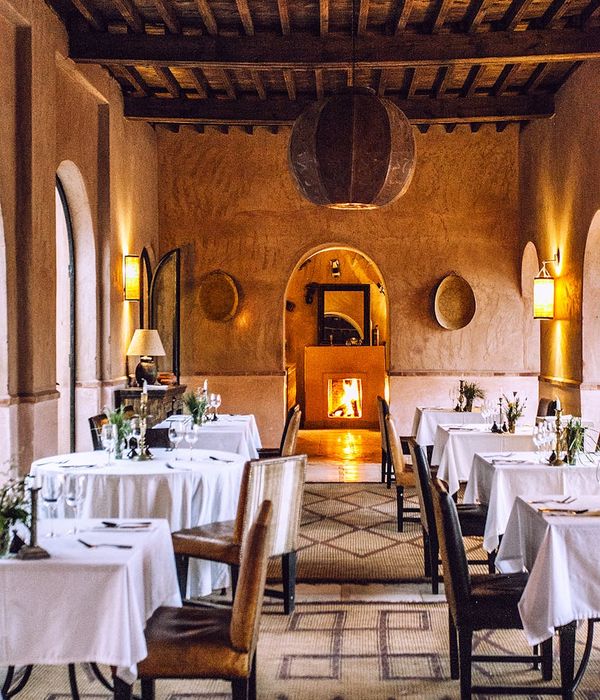 Boutique hotel restaurant with cozy fireplace and intimate dining atmosphere