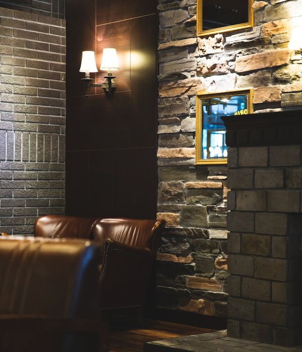 Elegant restaurant interior with sophisticated stone archways and warm ambient lighting