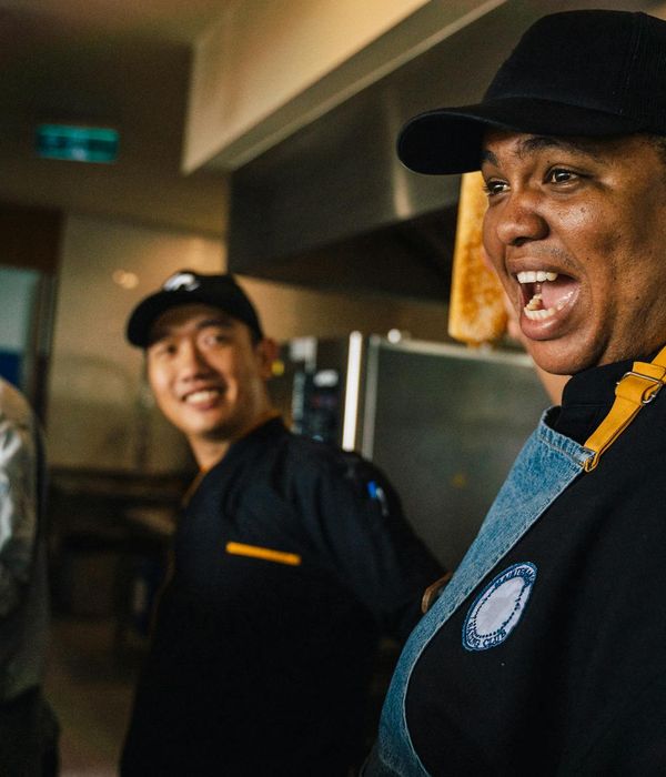 Professional chef team collaborating in modern restaurant kitchen environment